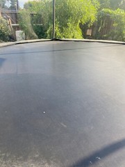 Green and black 15 ft trampoline with enclosure